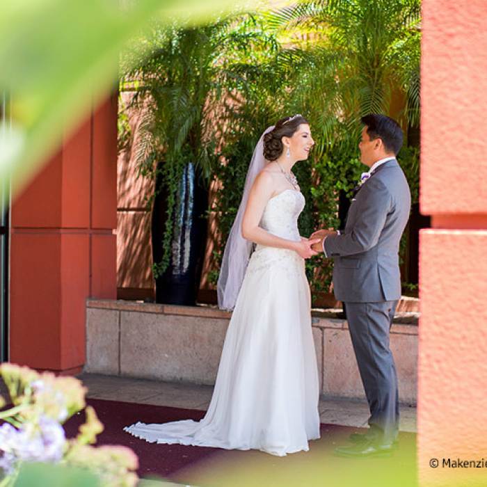 wedding picture of couple standing outside of hotel 