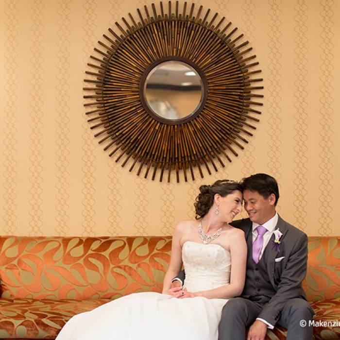wedding picture of couple sitting on a couch